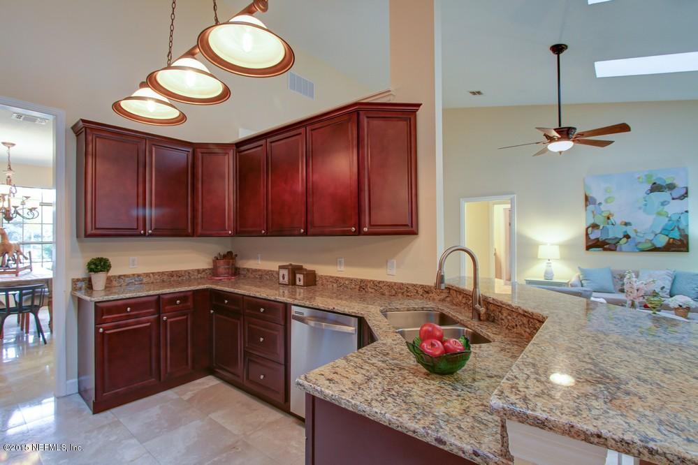 3038 Nautilus Road Middleburg, FL 32068 - Photo 11 of 45 a kitchen with stainless steel appliances granite countertop a sink and cabinets
