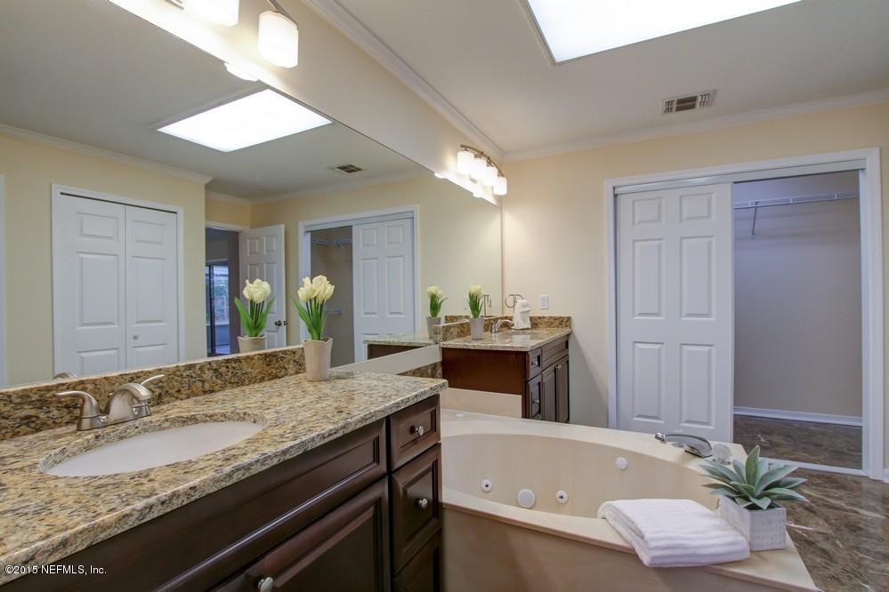 3038 Nautilus Road Middleburg, FL 32068 - Photo 21 of 45 a bathroom with a granite countertop tub sink and mirror