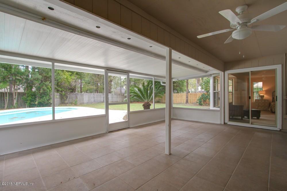 3038 Nautilus Road Middleburg, FL 32068 - Photo 29 of 45 a view of an empty room with a fireplace and a large window