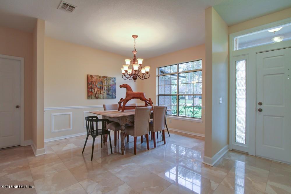 3038 Nautilus Road Middleburg, FL 32068 - Photo 3 of 45 a view of a dining room with furniture and chandelier