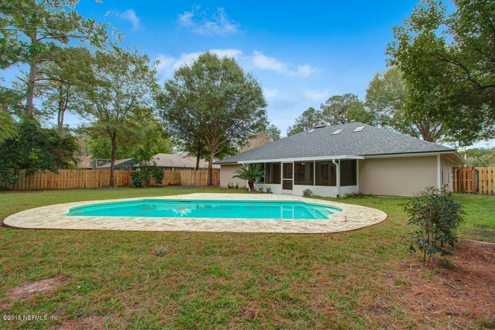 3038 Nautilus Road Middleburg, FL 32068 - Photo 32 of 45 a house with trees in the background