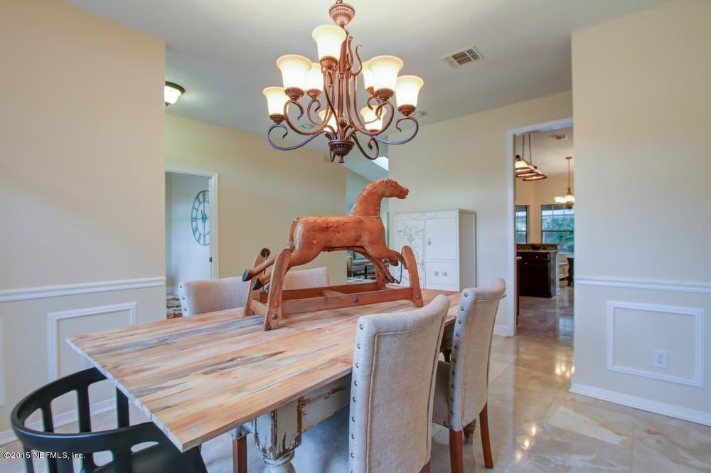 3038 Nautilus Road Middleburg, FL 32068 - Photo 4 of 45 a dining room filled chandelier and wooden floor