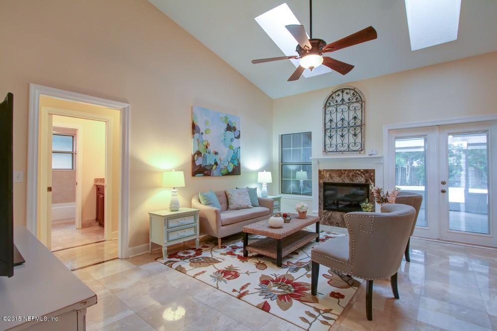 3038 Nautilus Road Middleburg, FL 32068 - Photo 6 of 45 a living room with furniture a clock and a fireplace