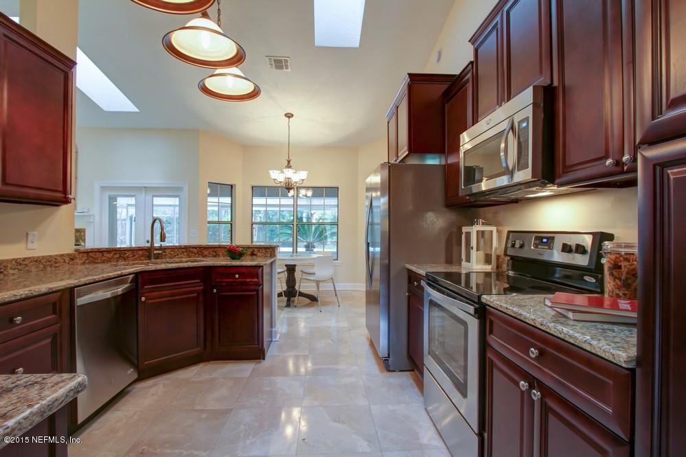 3038 Nautilus Road Middleburg, FL 32068 - Photo 10 of 45 a kitchen with stainless steel appliances granite countertop a stove and a sink