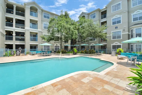 a view of a house with swimming pool and sitting area