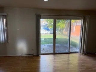 a view of room with window and wooden floor