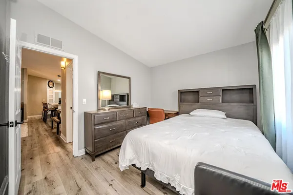 a bedroom with a bed and a dresser