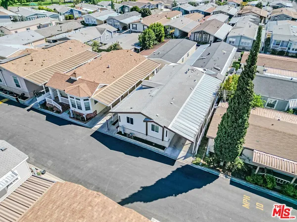 an aerial view of residential houses with outdoor space