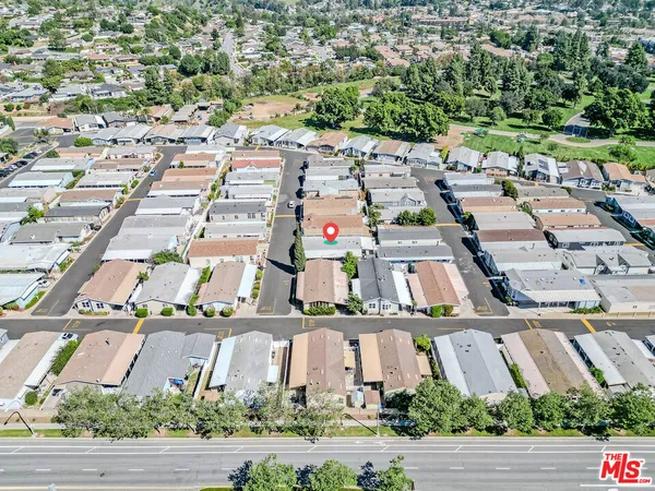 a view of a house with backyard and parking