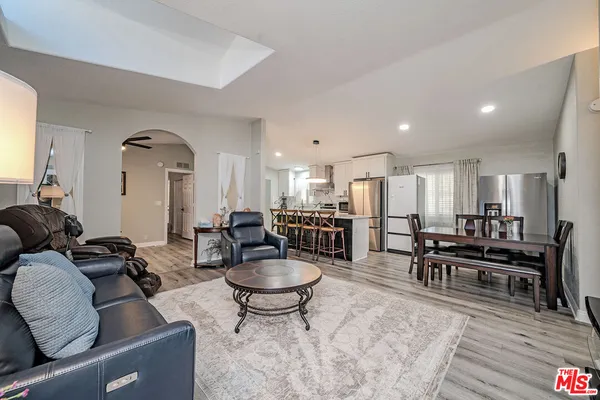 a living room with furniture and kitchen view