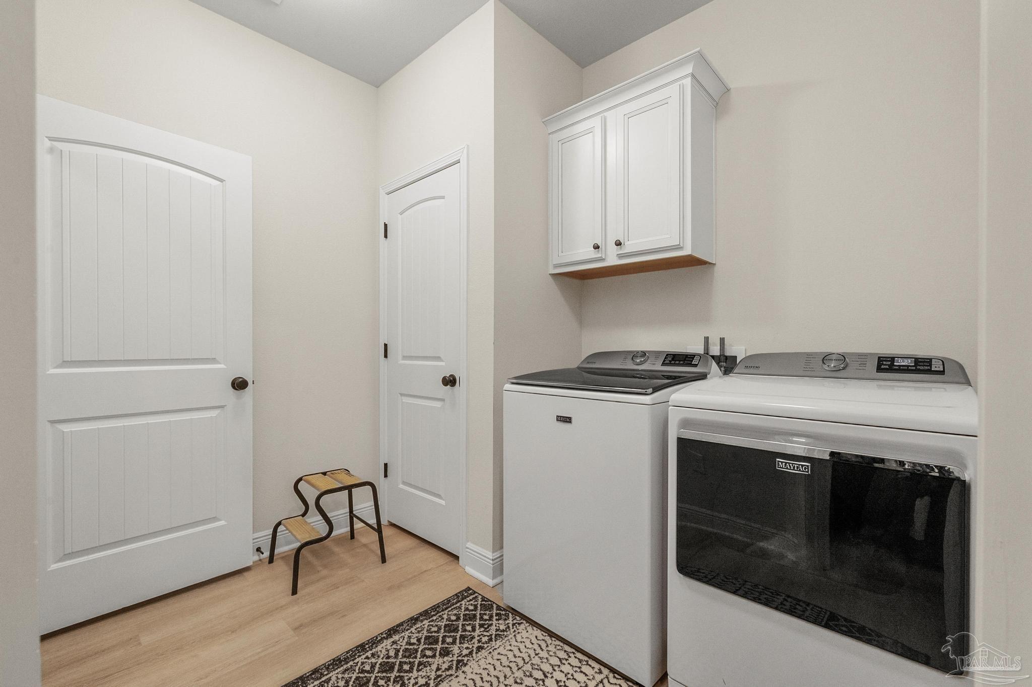 6070 Cherokee Drive Milton, FL 32570 - Photo 25 of 49 Laundry Room with Cabinet and Linen Closet