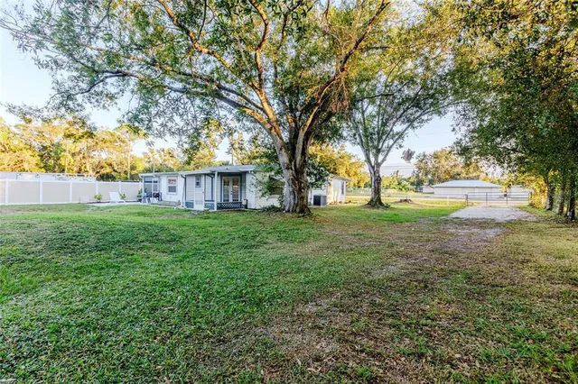 a view of a house with yard and tree s