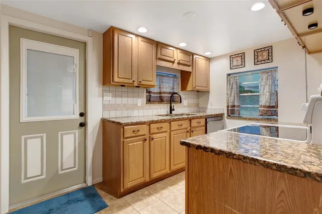 a view of a livingroom with wooden floor and a ceiling fan