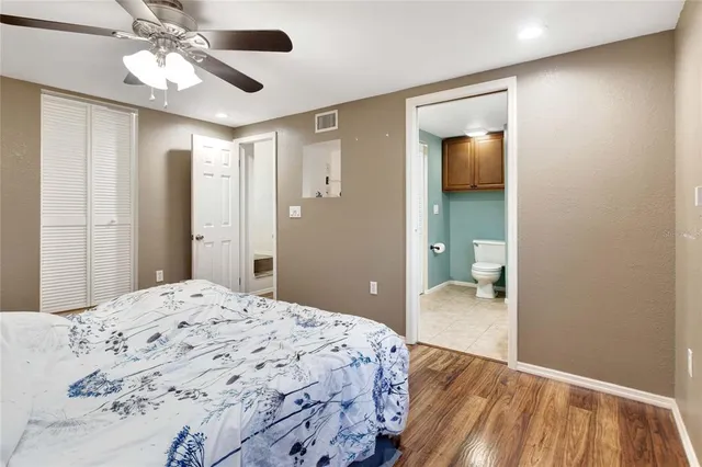 a bathroom with a granite countertop toilet sink and mirror
