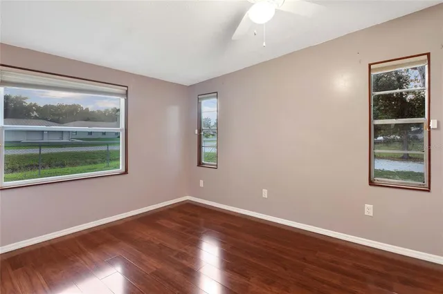 a view of a room with wooden floor and fan