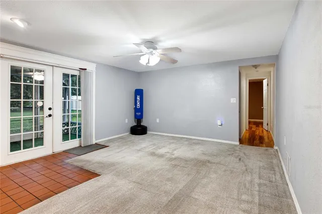 an empty room with a fan and a ceiling fan