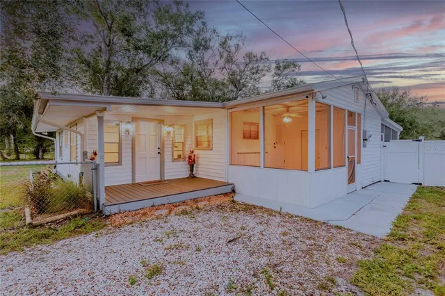 a view of a backyard with swimming pool