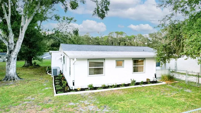 a view of a house with a yard and sitting area