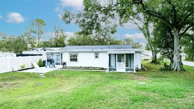a view of a house with backyard and sitting area