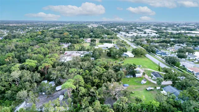 a view of a yard with an umbrella and a wooden fence