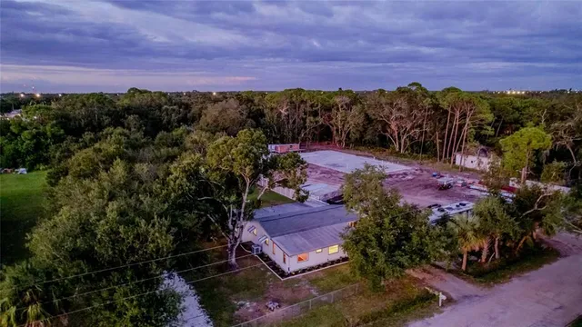 a view of a house with a backyard
