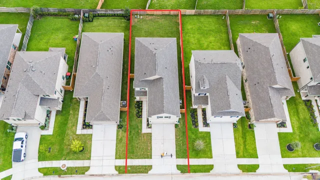 an aerial view of a house with a yard basket ball court and outdoor seating
