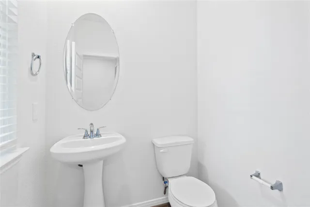 a kitchen with sink a microwave and cabinets