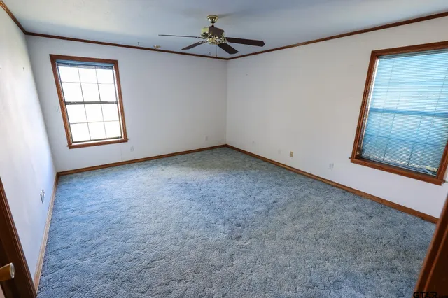 a view of an empty room with a window