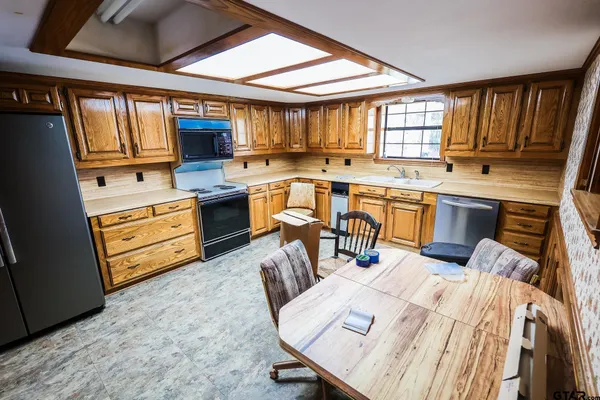 a kitchen with a sink appliances and cabinets