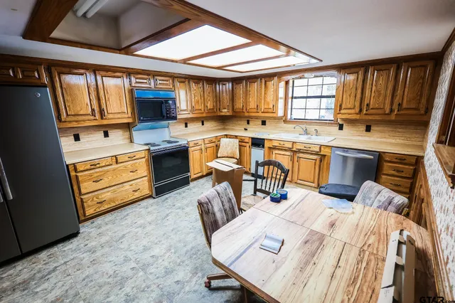 a kitchen with a sink appliances and cabinets