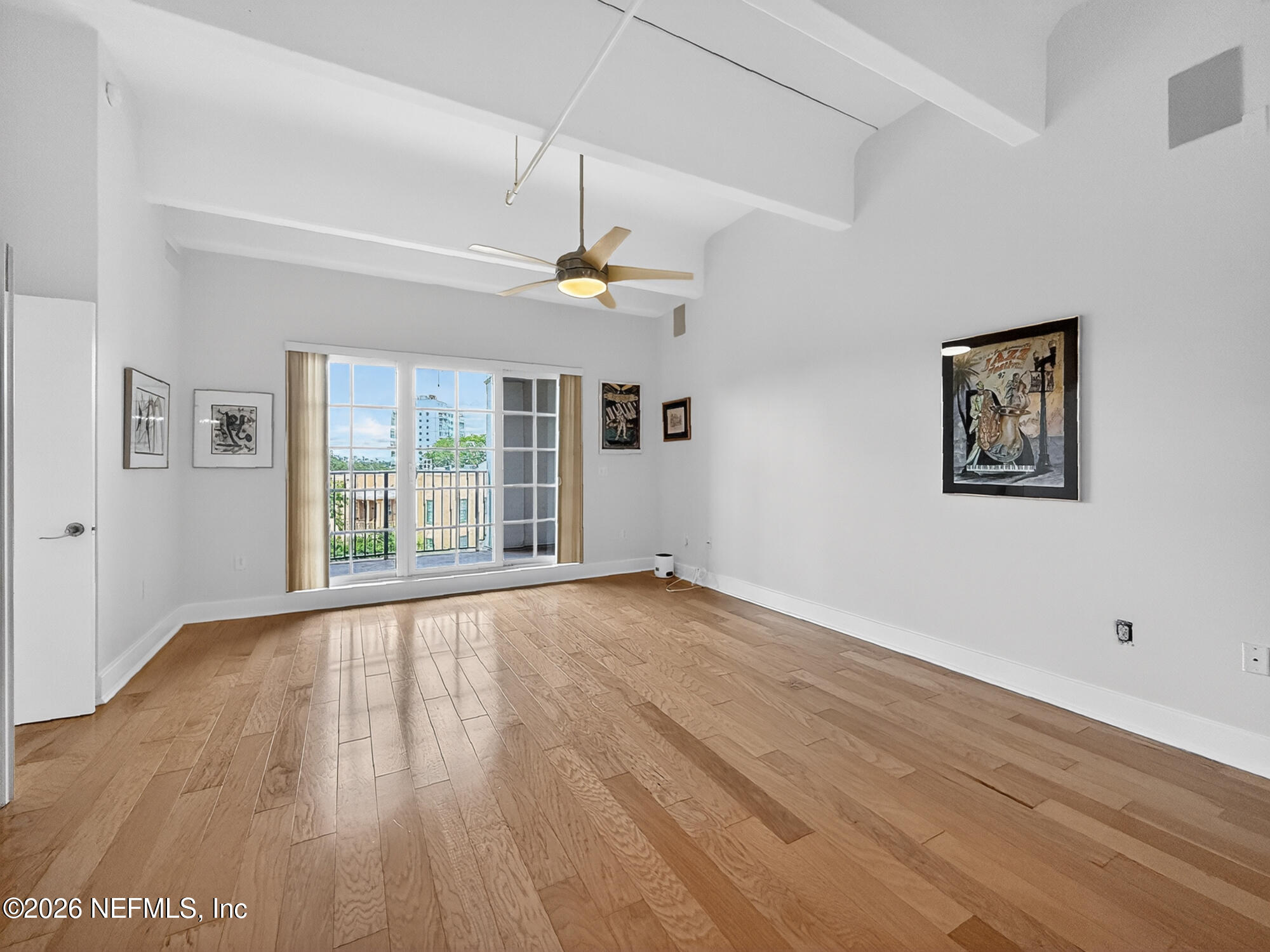 1661 Riverside Avenue, Unit 407 Jacksonville, FL 32204 - Photo 11 of 60 a view of an empty room with wooden floor and a window