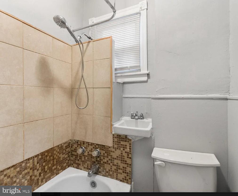 5224 Rodman Street Philadelphia, PA 19143 - Photo 11 of 12 a bathroom with a sink a toilet and shower