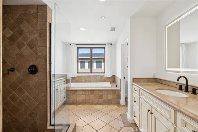 a bathroom with a tub sink and mirror