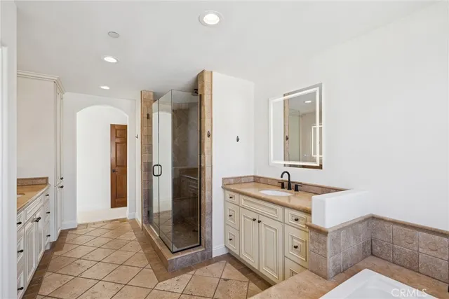 a spacious bathroom with a sink and a mirror