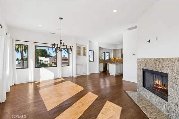 a living room with furniture large window and a fireplace