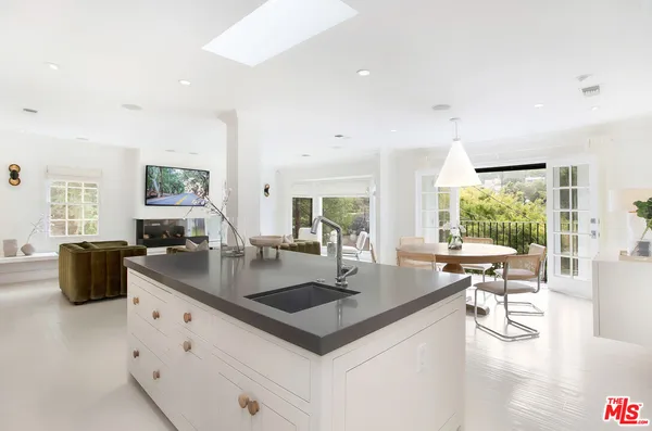 a kitchen with counter top space and living room