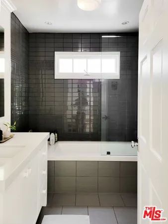 a bathroom with a bathtub and shower