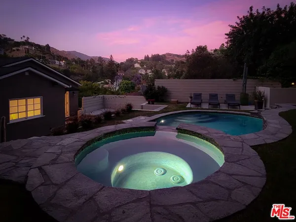 a view of a swimming pool with a patio