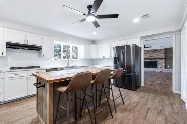 a view of a kitchen with wooden floor and a window