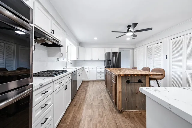 a bathroom with a sink and cabinets