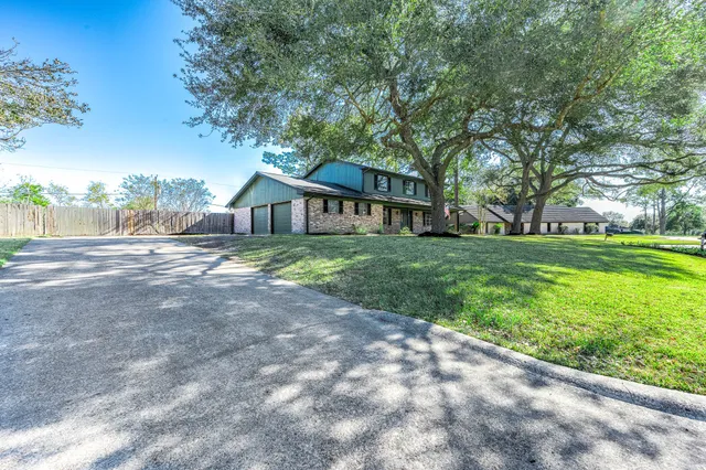 a house with huge green field in front of it