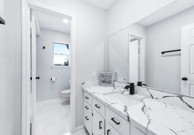 a bathroom with a bathtub shower sink and a mirror