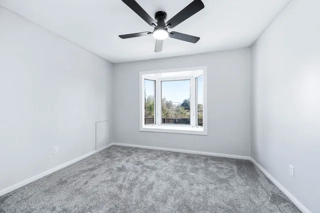 a view of yard with swimming pool and trees