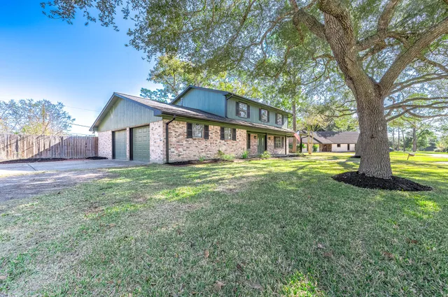 a view of a house with a yard and garage