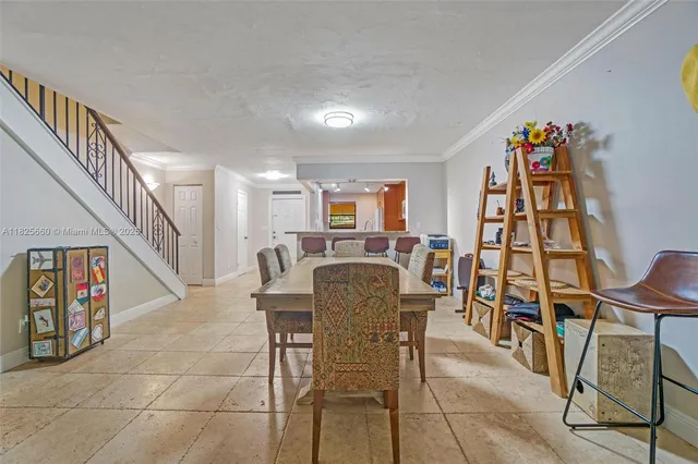 a dining room with furniture and entryway