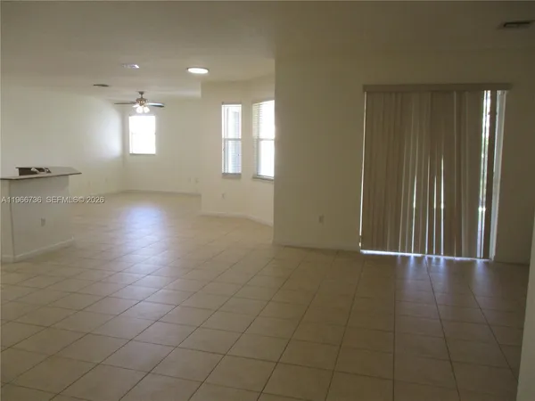 an empty room with windows and entrance