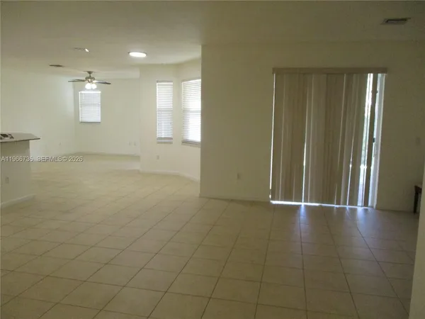a view of an empty room and a window