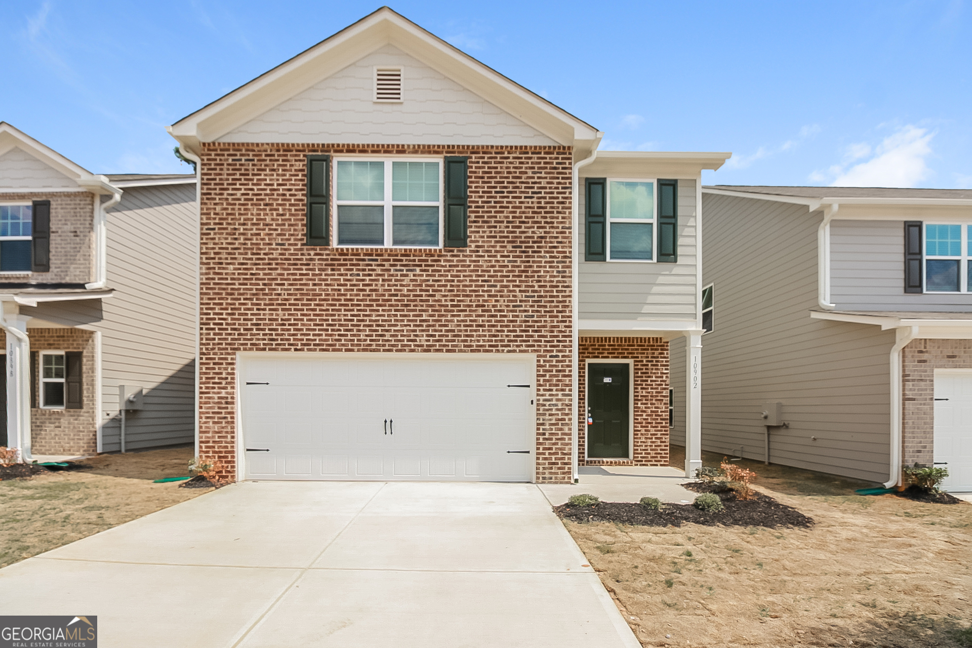 10902 Wheeler Trace Hampton, GA 30228 - Photo 1 of 17 a front view of a house with a yard and garage