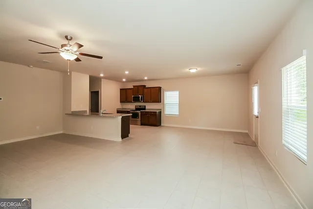 a view of kitchen with furniture and a ceiling fan