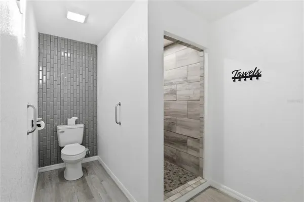 a bathroom with a toilet and a shower